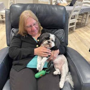 Senior Women hugging a dog